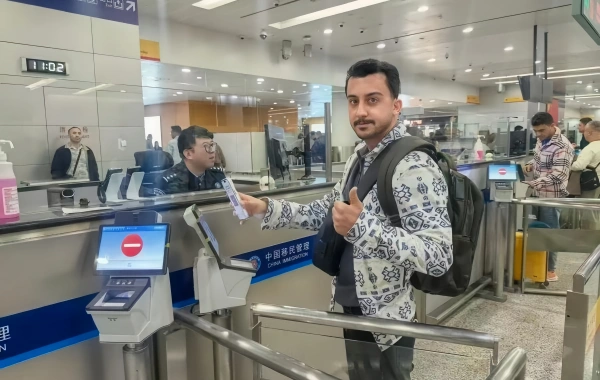 A man is processing his entry card.
