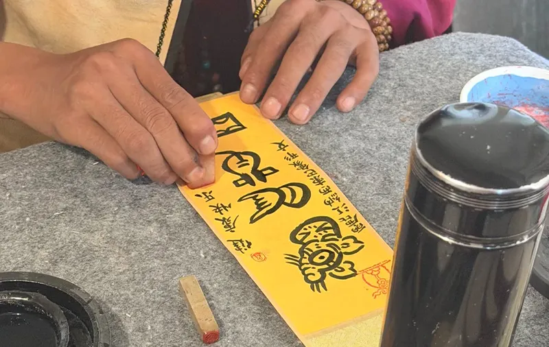 Dongba script writing makes Naxi culture tangible in a few careful strokes